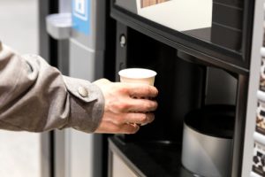 Man,hand,with,coffee,,vending,coffee,machine
